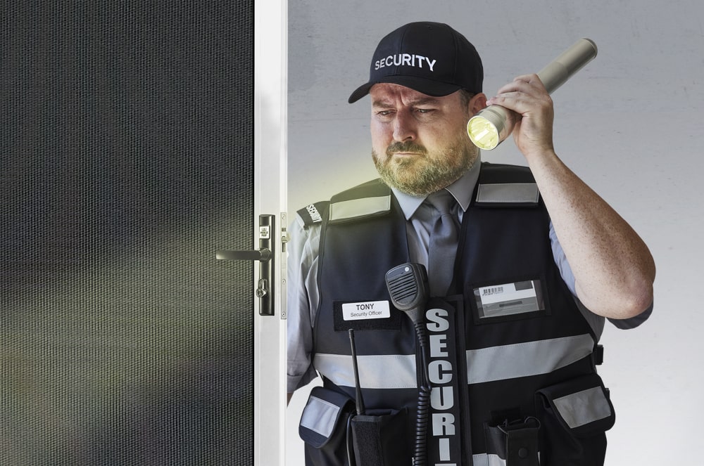 Tony security guarding aiming flashlight on prowler proof secuirty screen door