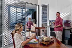 Prowler Proof Diamond Design Security Sliding Screens, with family eating lunch.