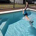 Image of child jumping into pool