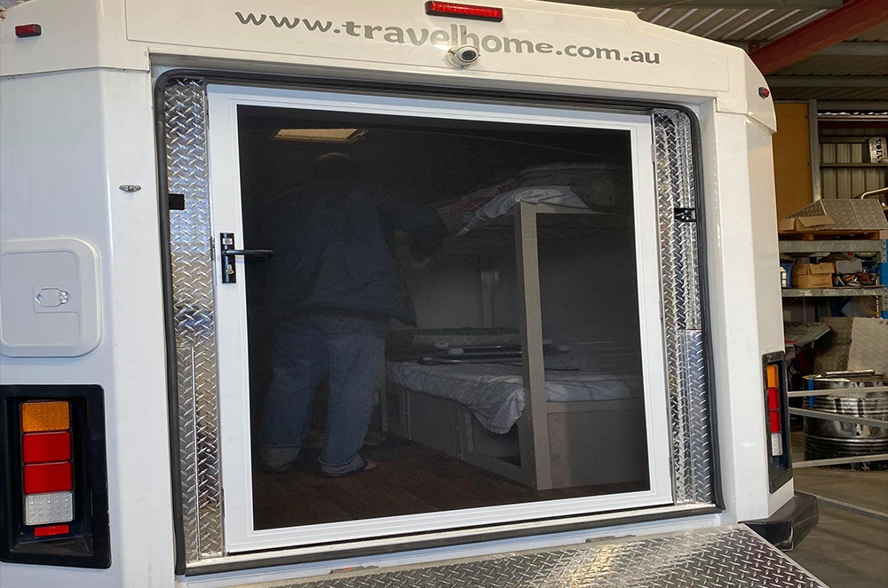 ForceField hinge door on back of caravan